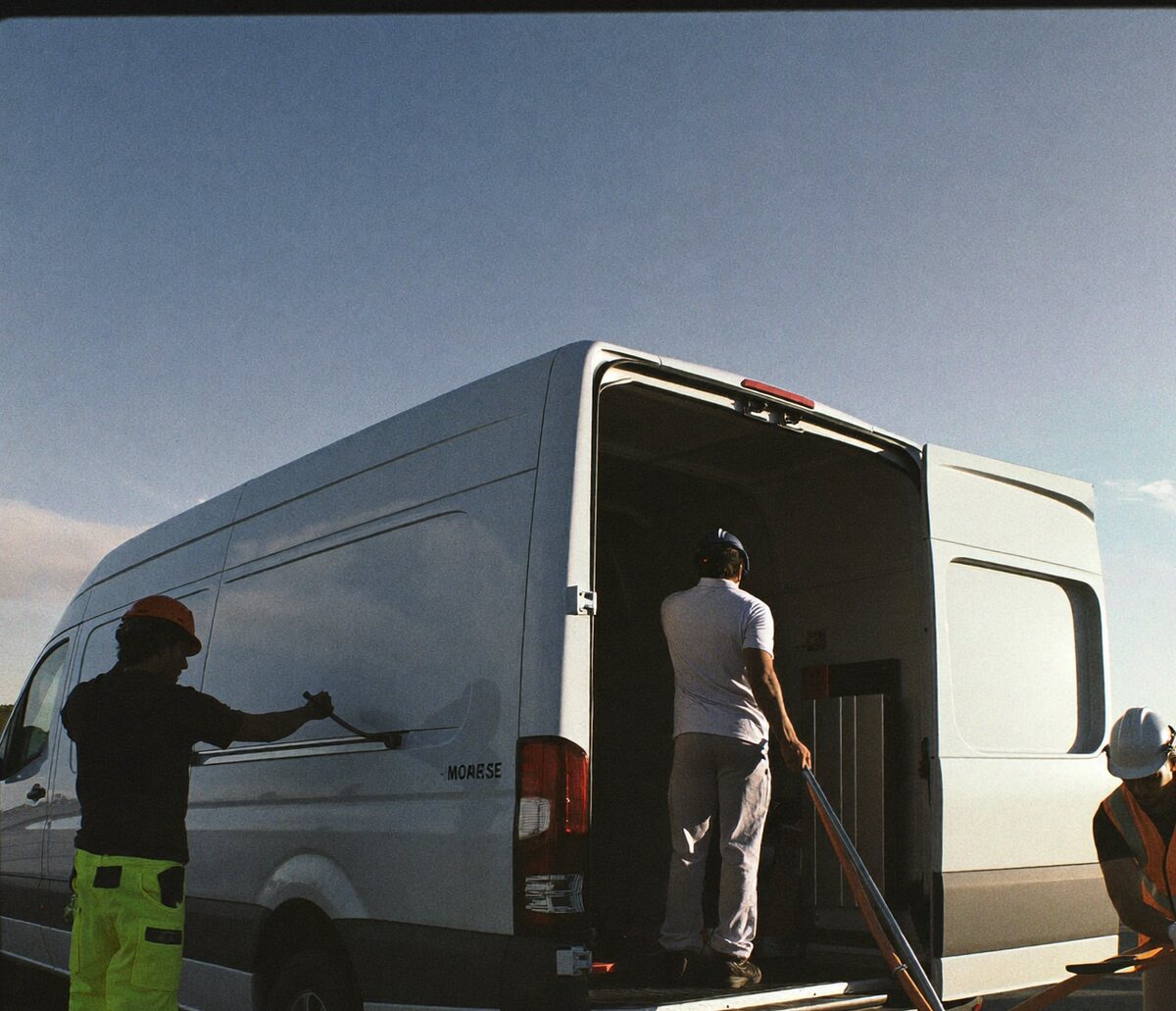 A crew loading a work van at dawn